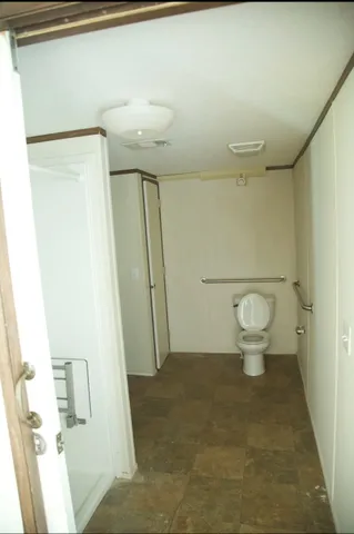 a bathroom with a toilet and a shower