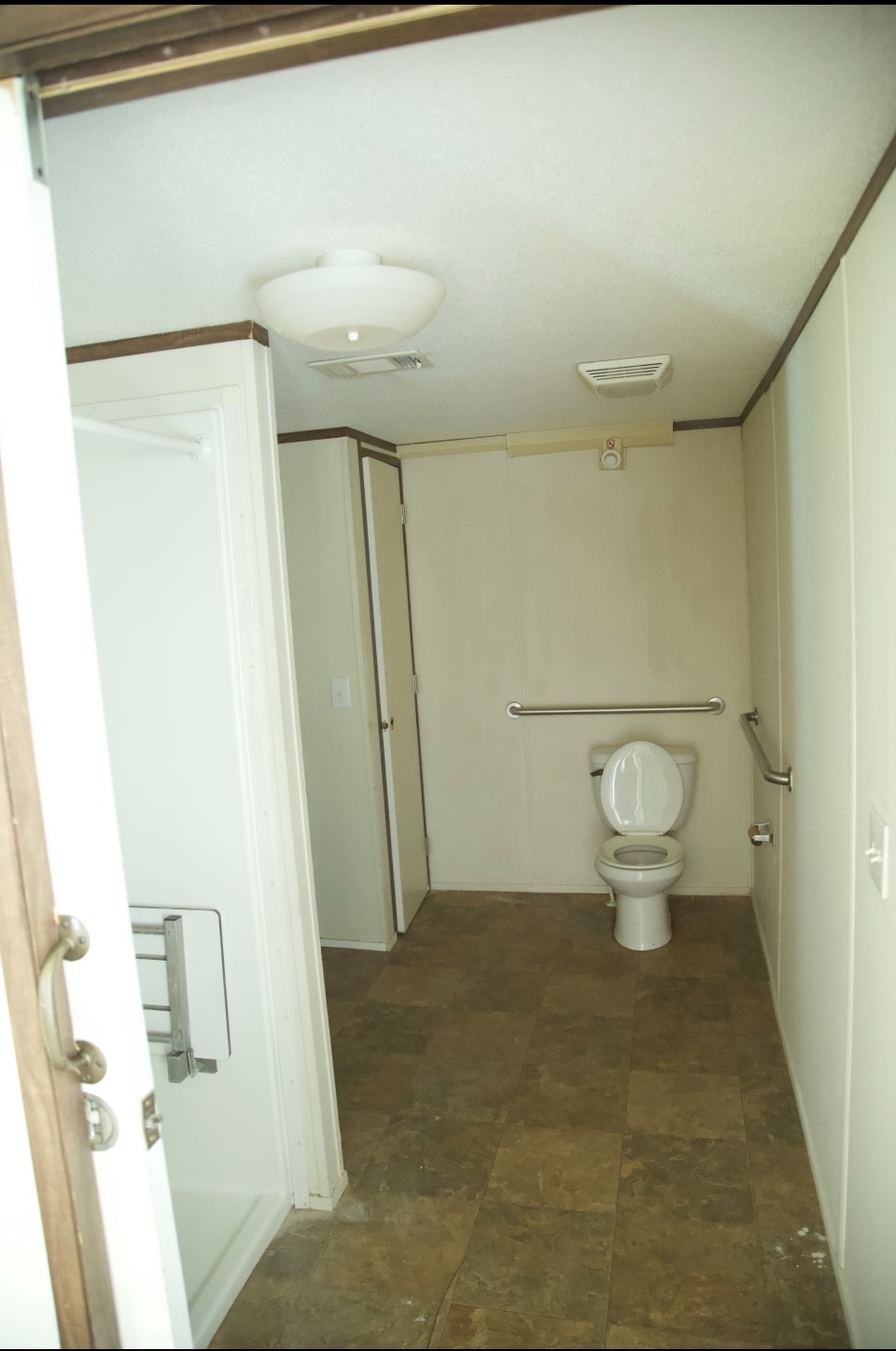4443 6th Street Bacliff, TX 77518 - Photo 7 of 8 a bathroom with a toilet and a shower