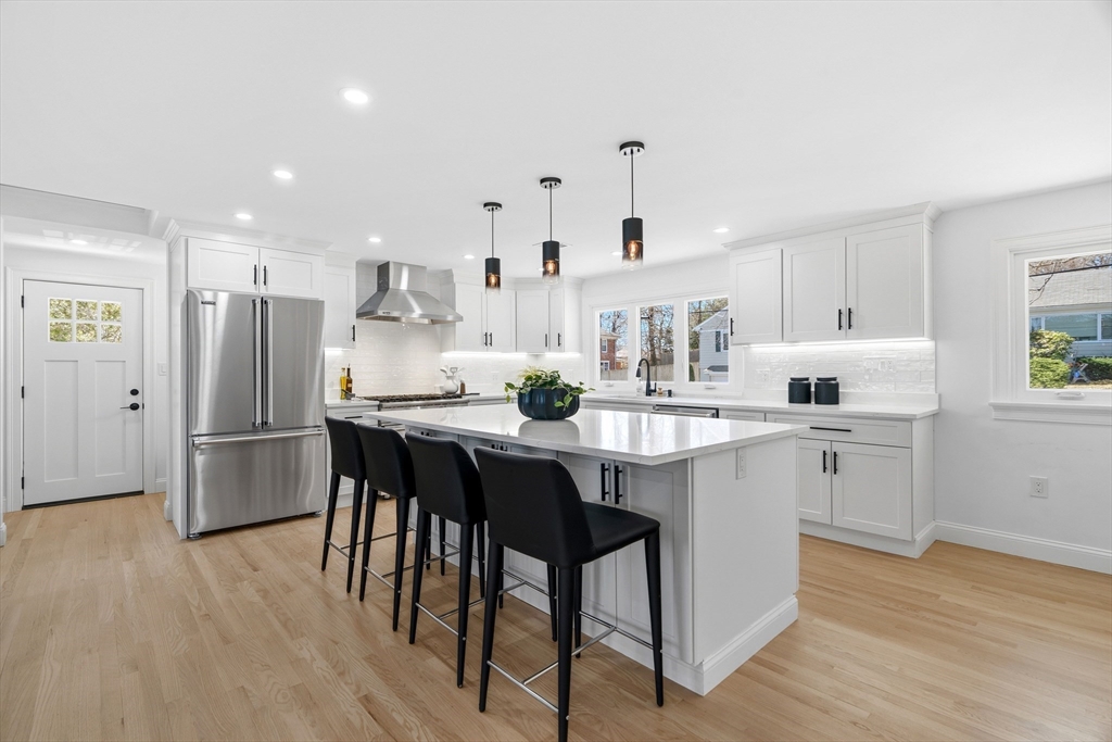 171 Shaw Road Brookline, MA 02467 - Photo 6 of 42 a kitchen with white cabinets and stainless steel appliances