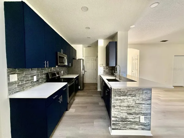 a kitchen with a sink stove and refrigerator