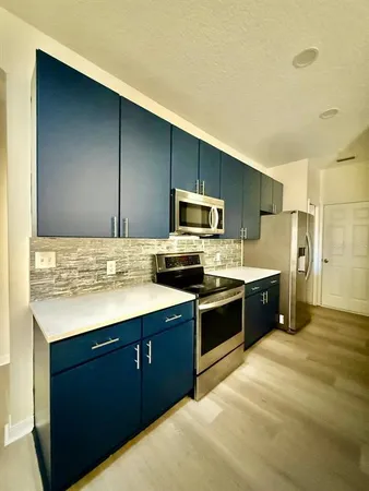a kitchen with stainless steel appliances kitchen island granite countertop a sink and cabinets