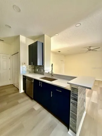 a bathroom with a granite countertop double vanity sink and mirror