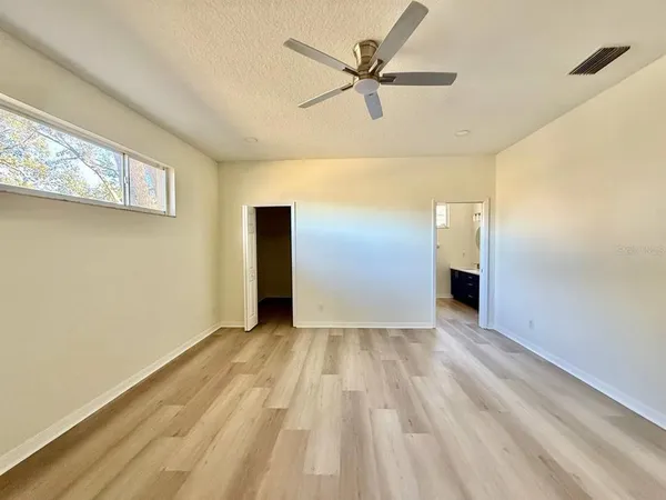 a view of empty room with wooden floor