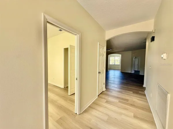a view of a hallway with wooden floor