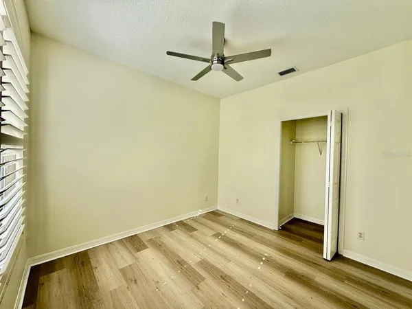 a view of a room with a ceiling fan
