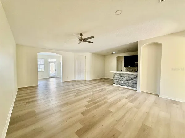 a view of empty room with a fireplace and wooden floor