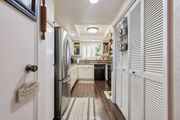 a kitchen with stainless steel appliances a white cabinets and a sink