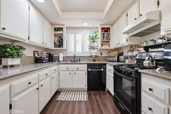 a kitchen that has a sink and a stove in it