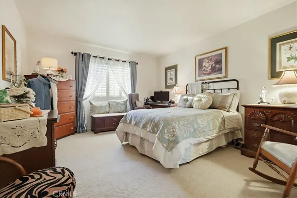 a view of a hallway with closet and a bathroom
