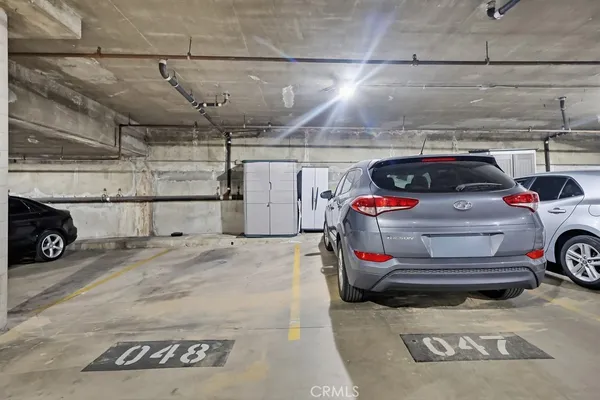 a view of parking garage with cars parked