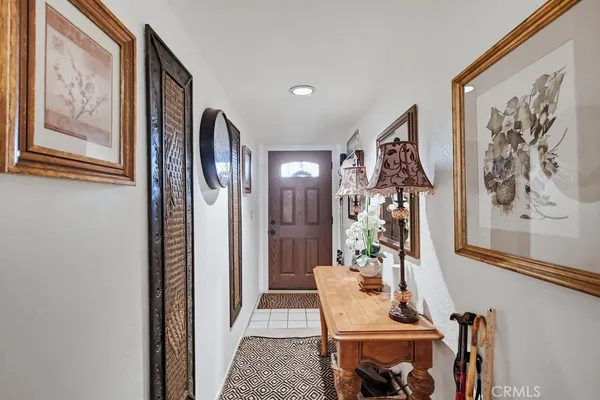 a living room with furniture a chandelier and a dining table