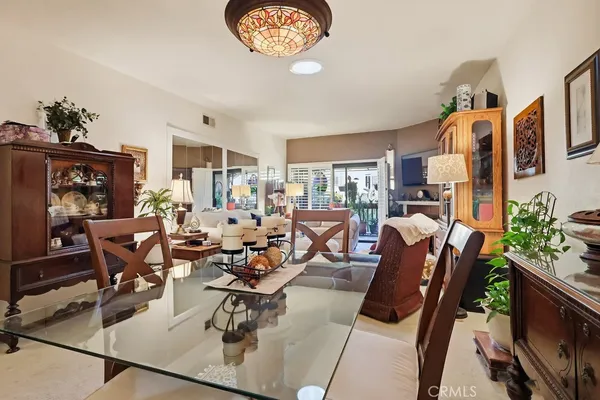 a living room with furniture a fireplace and a large window