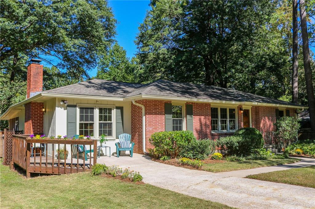 2596 Wood Trail Lane Decatur, GA 30033 - Photo 1 of 1 a front view of a house with a yard table and chairs