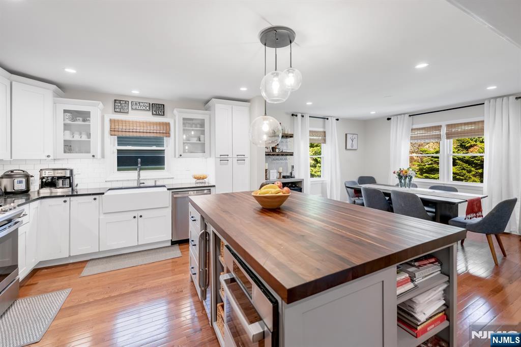 433 Piermont Road Cresskill, NJ 07626 - Photo 11 of 49 a kitchen with stainless steel appliances granite countertop a stove refrigerator sink and cabinets