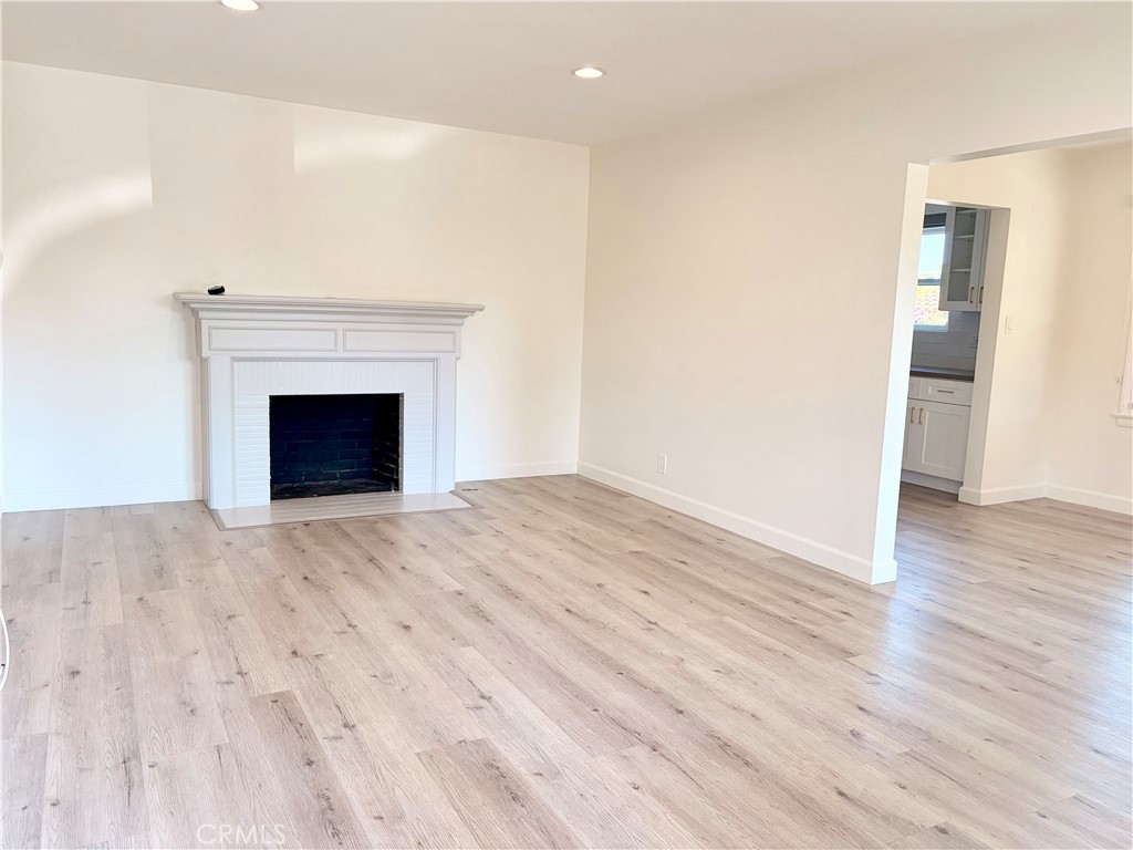 100 Eastern Pasadena, CA 91107 - Photo 6 of 18 a view of an empty room with wooden floor fireplace and a window