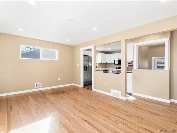 a view of a kitchen with wooden floor