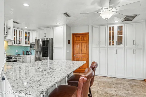 a dining room with furniture and a floor to ceiling window