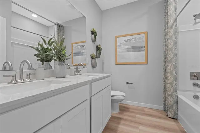 a bathroom with a double vanity sink and a mirror