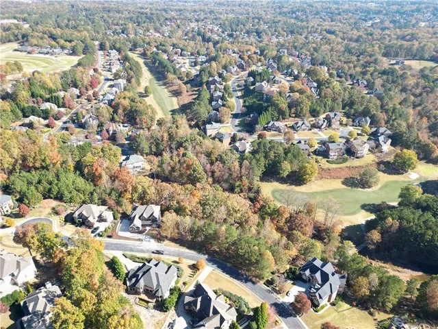 an aerial view of a house with a yard and lake view