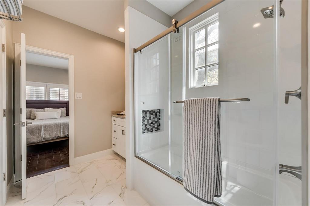 2902 North Pearl Street Dallas, TX 75201 - Photo 23 of 36 Ensuite bathroom featuring vanity, baseboards, marble finish floor, ensuite bath, and combined bath / shower with glass door