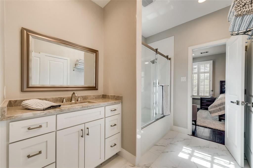 2902 North Pearl Street Dallas, TX 75201 - Photo 25 of 36 Ensuite bathroom with baseboards, marble finish floor, vanity, ensuite bath, and shower / bath combination with glass door