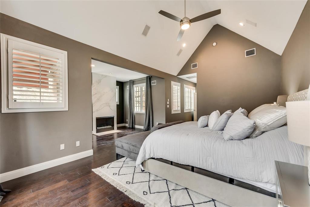 2902 North Pearl Street Dallas, TX 75201 - Photo 28 of 36 Bedroom featuring a premium fireplace, high vaulted ceiling, baseboards, visible vents, and wood finished floors