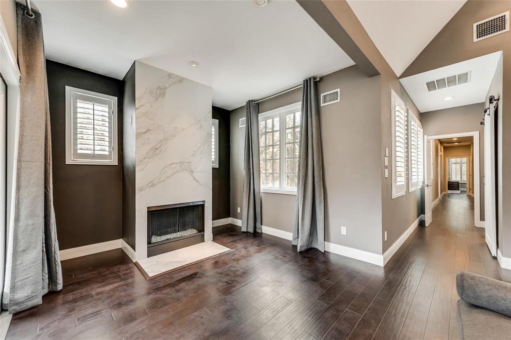 2902 North Pearl Street Dallas, TX 75201 - Photo 29 of 36 Primary bedroom with visible vents, wood finished floors, and a premium fireplace