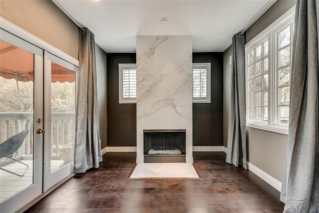 2902 North Pearl Street Dallas, TX 75201 - Photo 31 of 36 Primary bedroom with plenty of natural light, baseboards, a fireplace, and wood finished floors