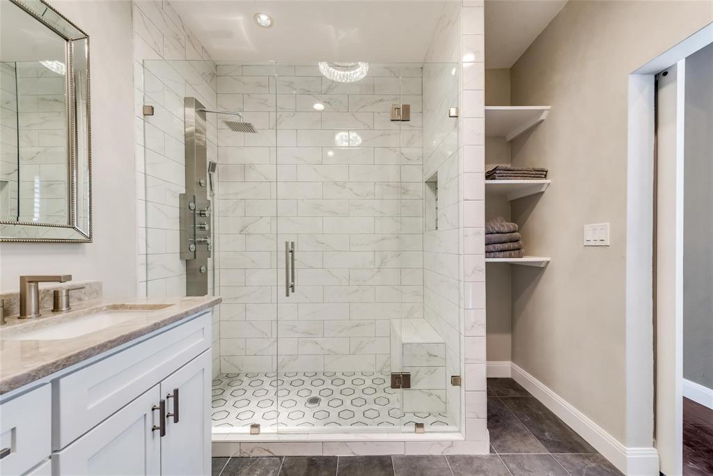 2902 North Pearl Street Dallas, TX 75201 - Photo 32 of 36 Bathroom featuring baseboards, vanity, and a shower stall