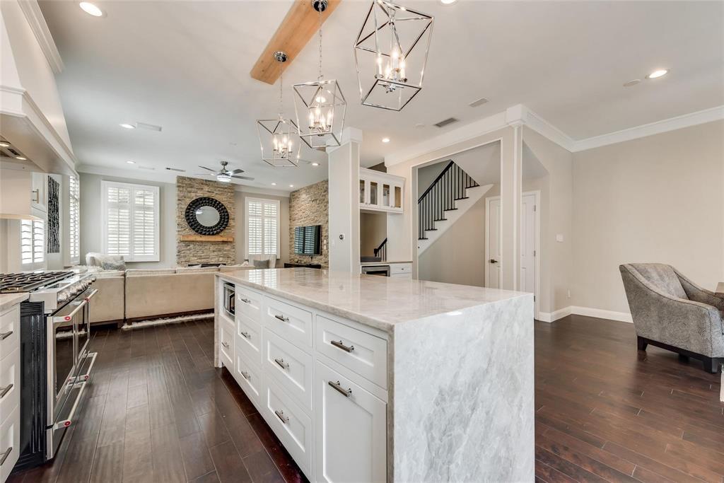 2902 North Pearl Street Dallas, TX 75201 - Photo 35 of 36 Kitchen featuring ceiling fan with notable chandelier, open floor plan, range with two ovens, and ornamental molding