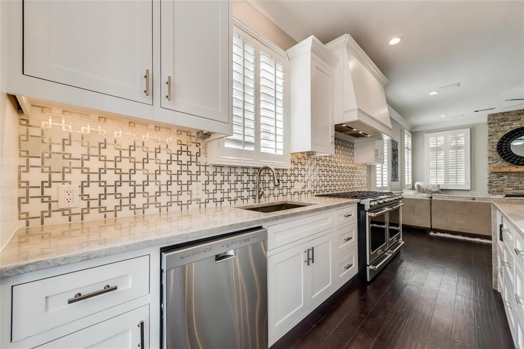 2902 North Pearl Street Dallas, TX 75201 - Photo 36 of 36 Kitchen with open floor plan, premium range hood, stainless steel appliances, backsplash, and a sink