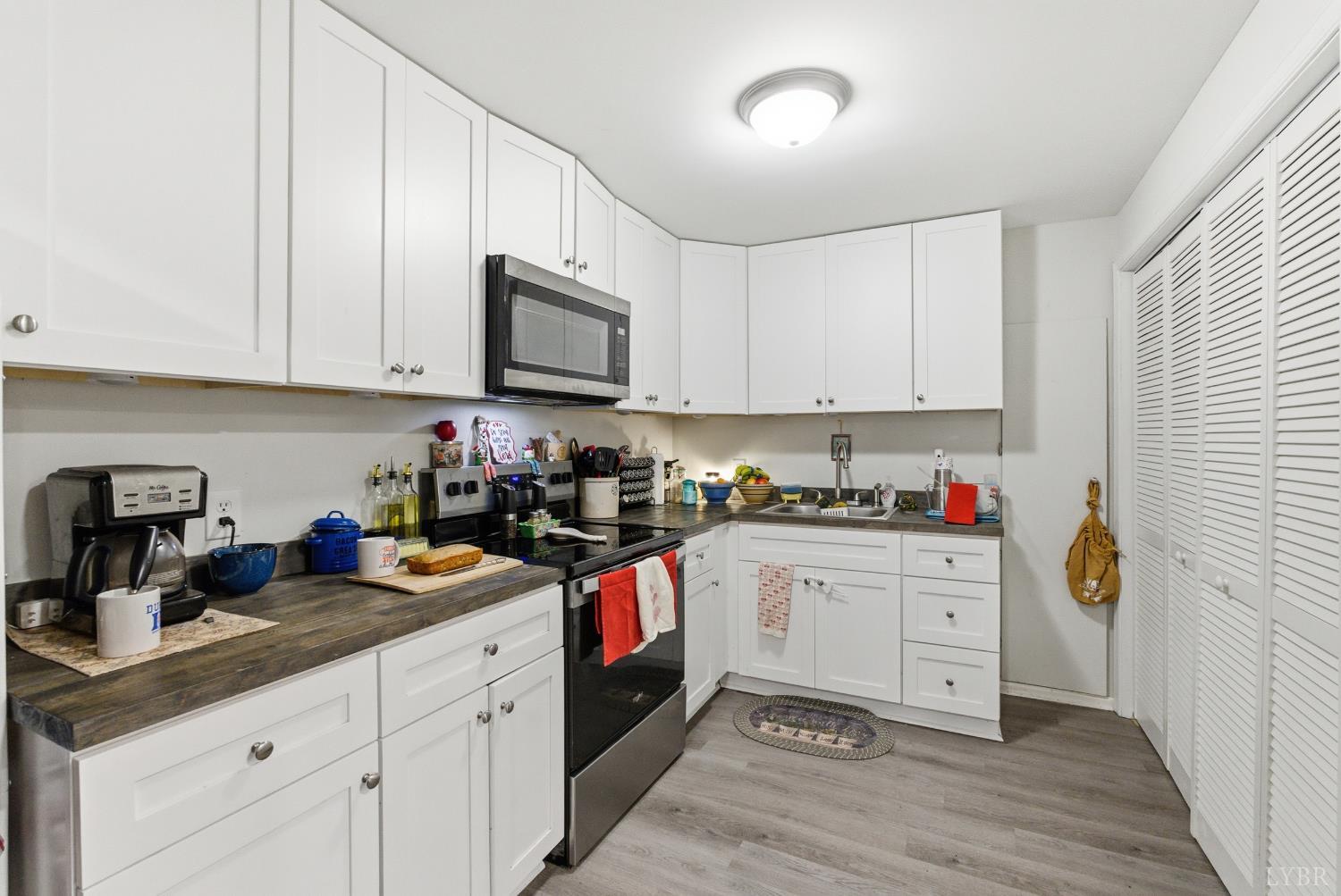 5225 Blue Ridge Drive Gretna, VA 24557 - Photo 20 of 28 a kitchen with stainless steel appliances granite countertop a sink stove and cabinets