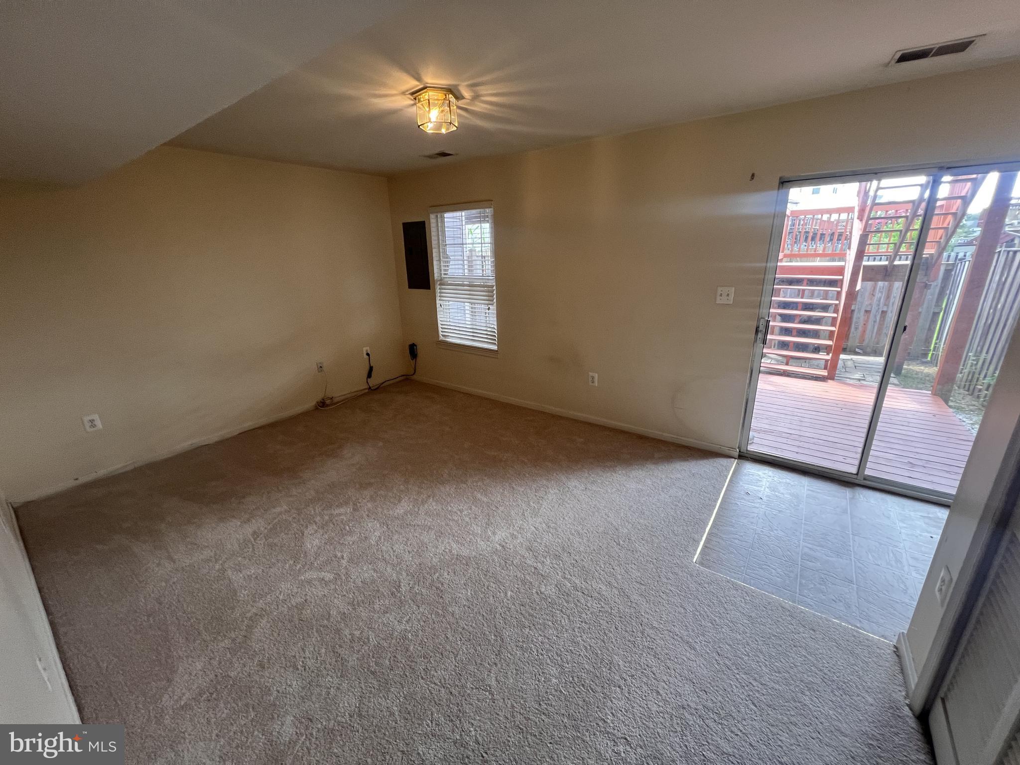 8871 Dunstable Loop Bristow, VA 20136 - Photo 2 of 10 an empty room with windows and entrance