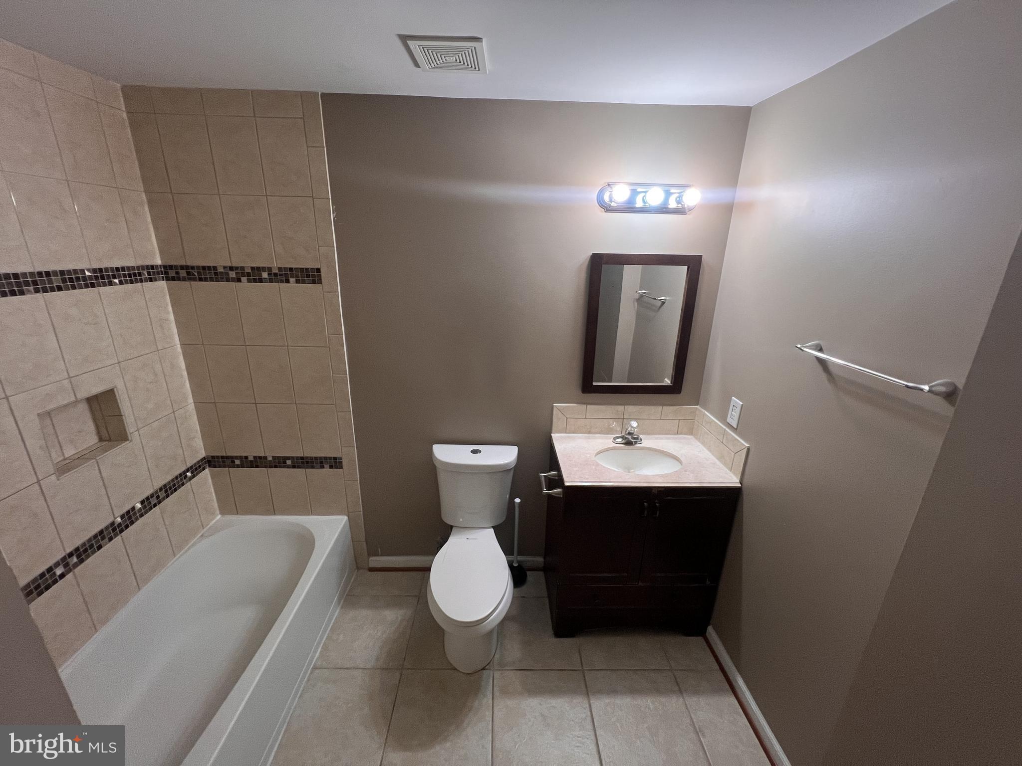8871 Dunstable Loop Bristow, VA 20136 - Photo 3 of 10 a bathroom with a sink a toilet and shower