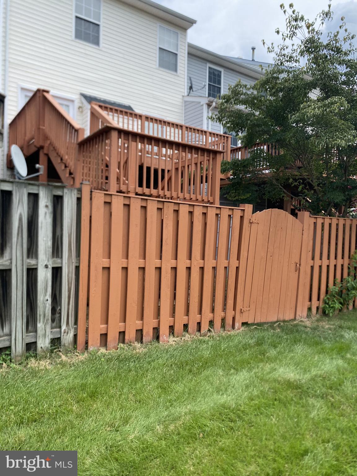 8871 Dunstable Loop Bristow, VA 20136 - Photo 10 of 10 a view of a house with backyard and wooden fence