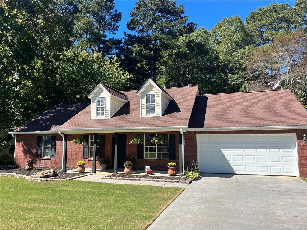 a front view of a house with swimming pool and chairs