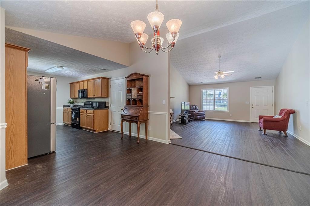 309 Magnolia Lane Monroe, GA 30655 - Photo 15 of 25 a view of a dining room and livingroom with furniture wooden floor