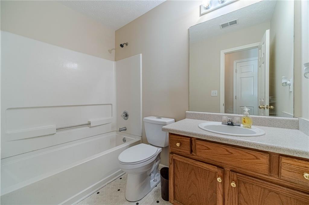 309 Magnolia Lane Monroe, GA 30655 - Photo 17 of 25 a bathroom with a sink a toilet and shower