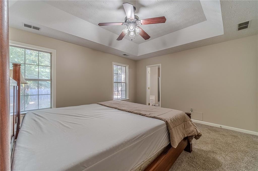309 Magnolia Lane Monroe, GA 30655 - Photo 22 of 25 a bedroom with a bed and a chandelier