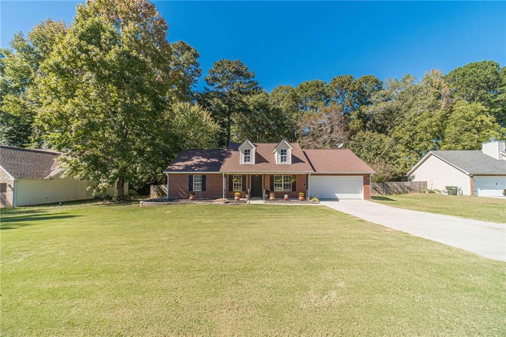 309 Magnolia Lane Monroe, GA 30655 - Photo 4 of 25 a front view of a house with a garden and mountain view