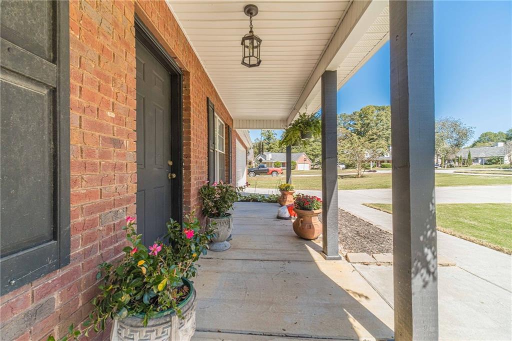 309 Magnolia Lane Monroe, GA 30655 - Photo 9 of 25 a porch with a table and chairs in patio