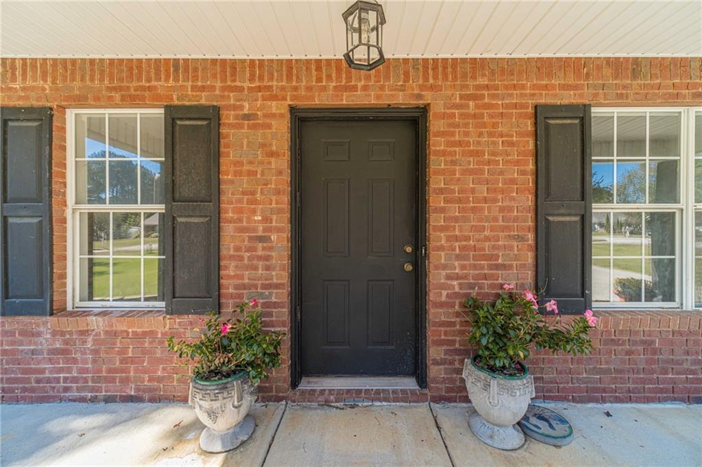 309 Magnolia Lane Monroe, GA 30655 - Photo 10 of 25 a front view of a house with a potted plant
