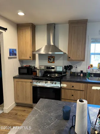 a kitchen with a stove a sink and a refrigerator