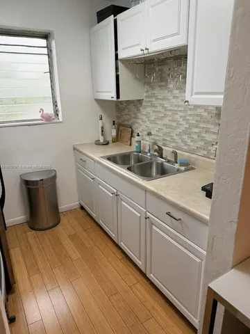 a kitchen with a sink and cabinets