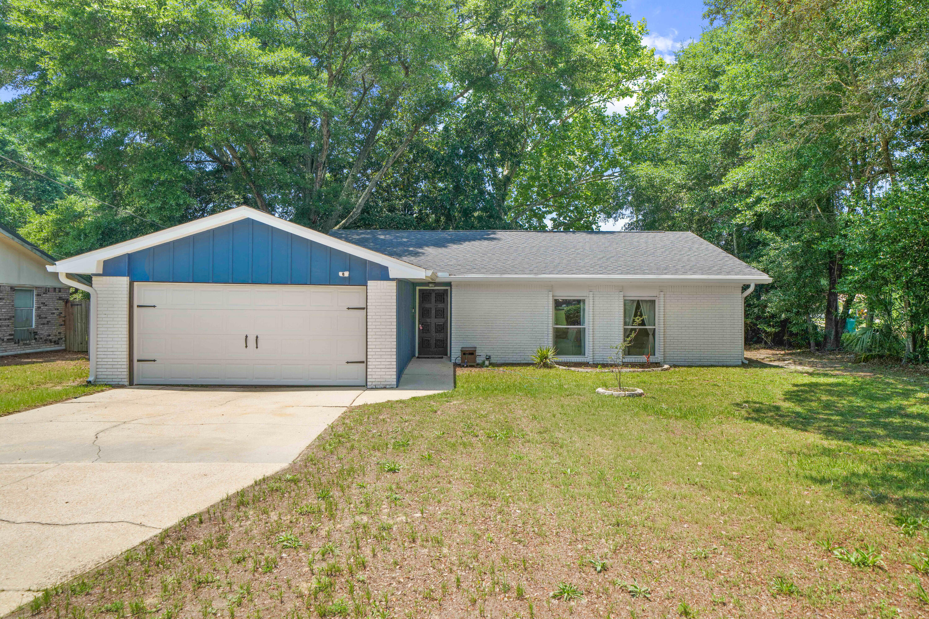 39 9th Street Shalimar, FL 32579 - Photo 1 of 37 a house with trees in the background