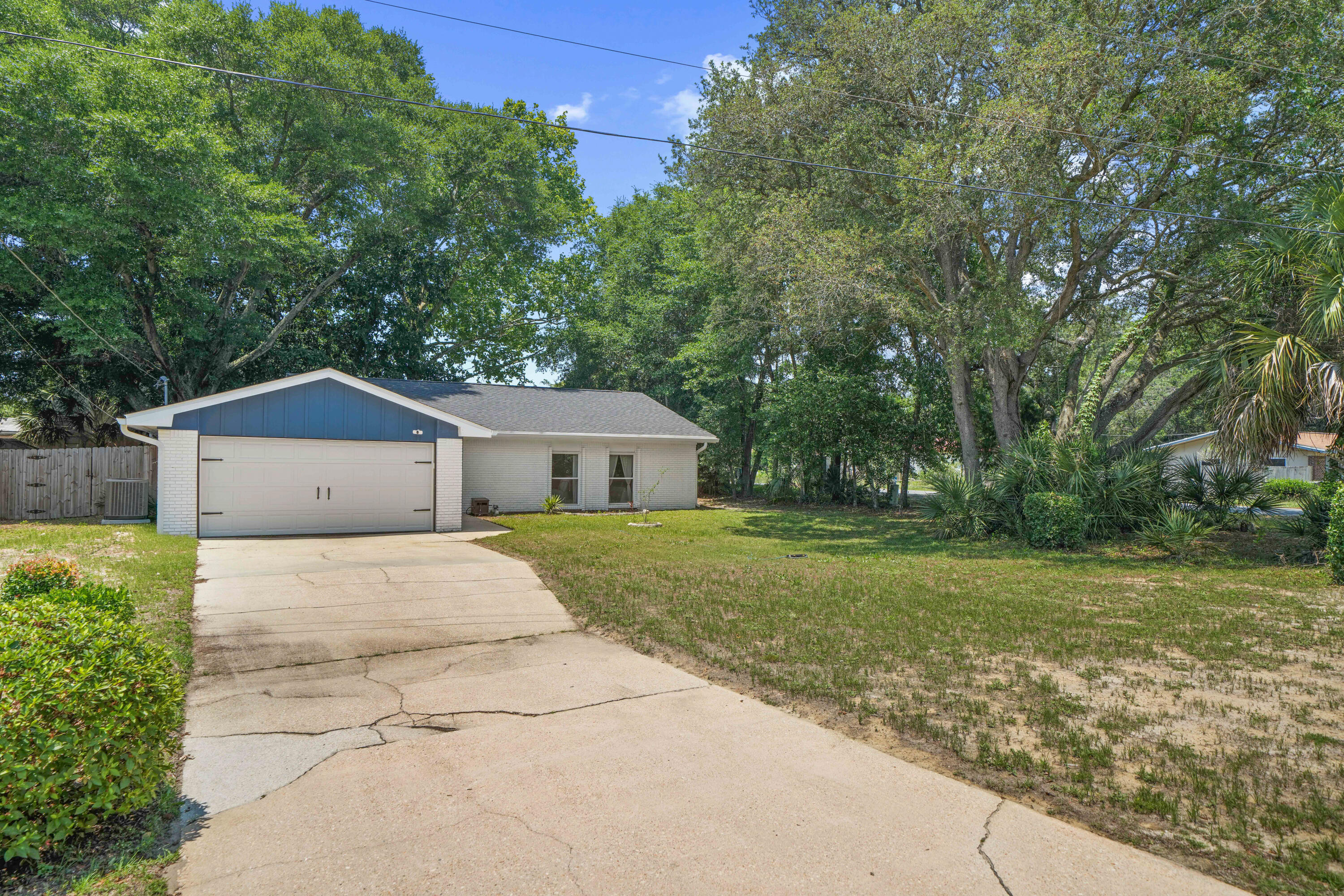 39 9th Street Shalimar, FL 32579 - Photo 2 of 37 a front view of a house with a yard and trees