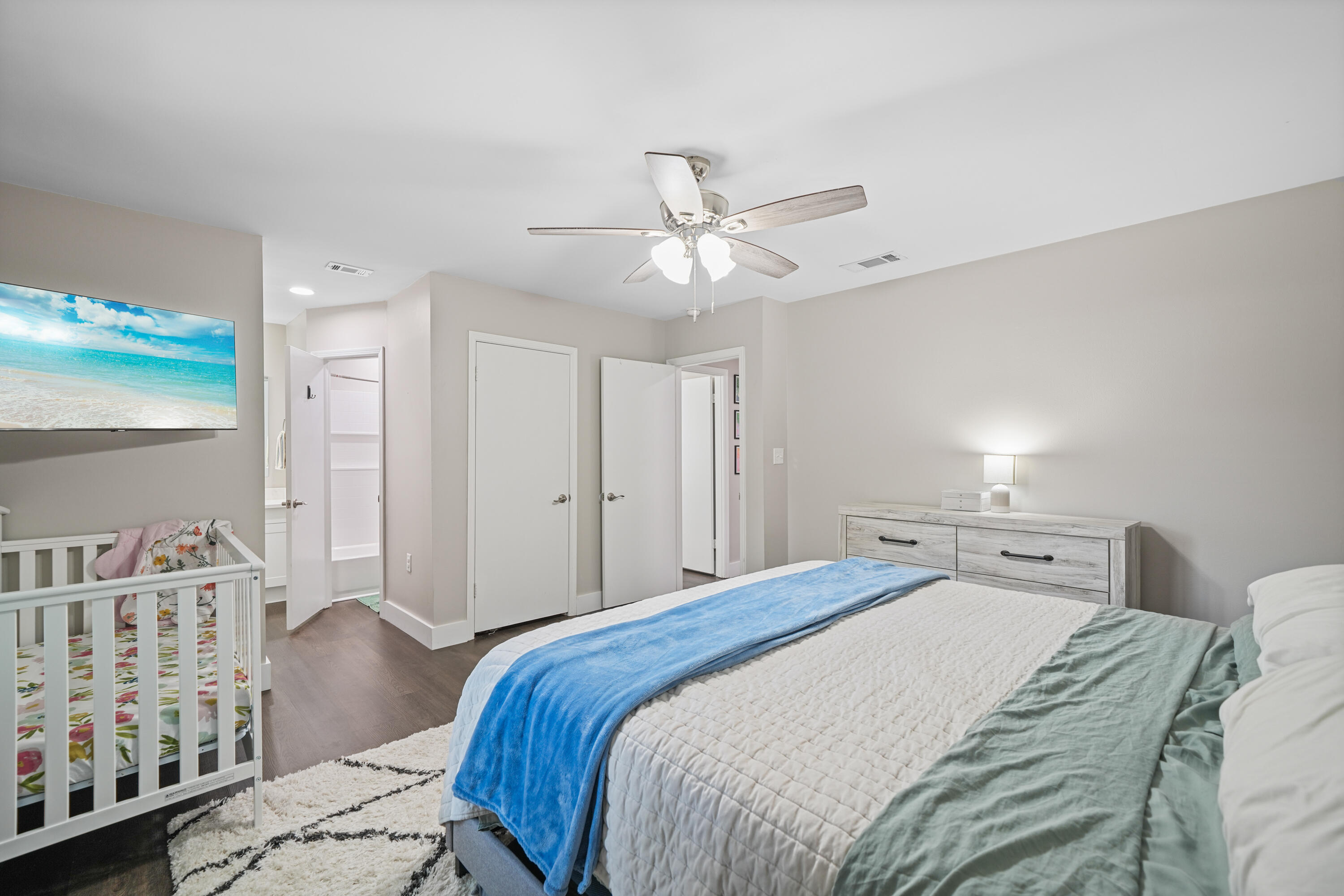 39 9th Street Shalimar, FL 32579 - Photo 24 of 37 a bedroom with a large bed and a chandelier