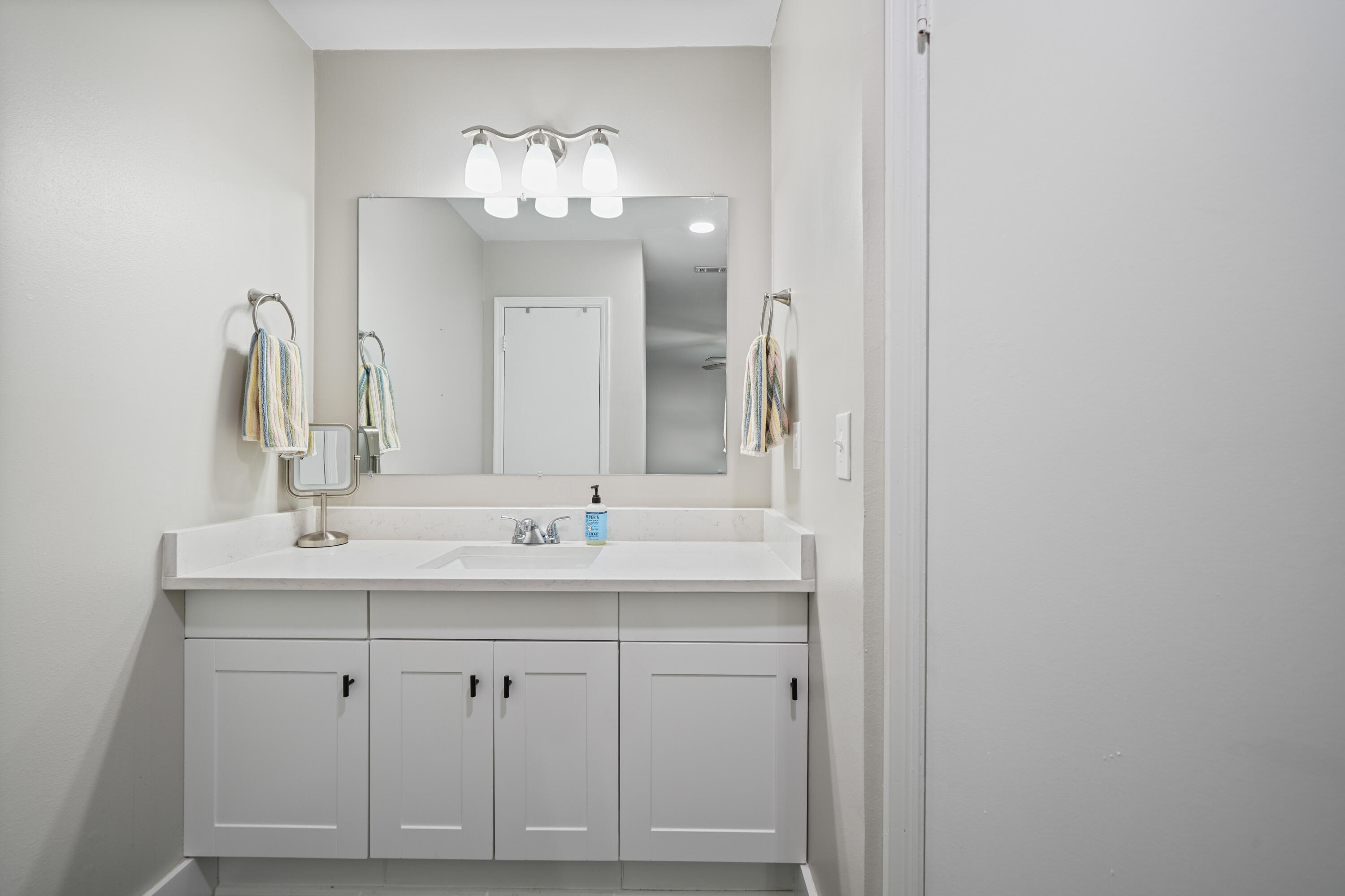 39 9th Street Shalimar, FL 32579 - Photo 28 of 37 a bathroom with double vanity sinks and a mirror