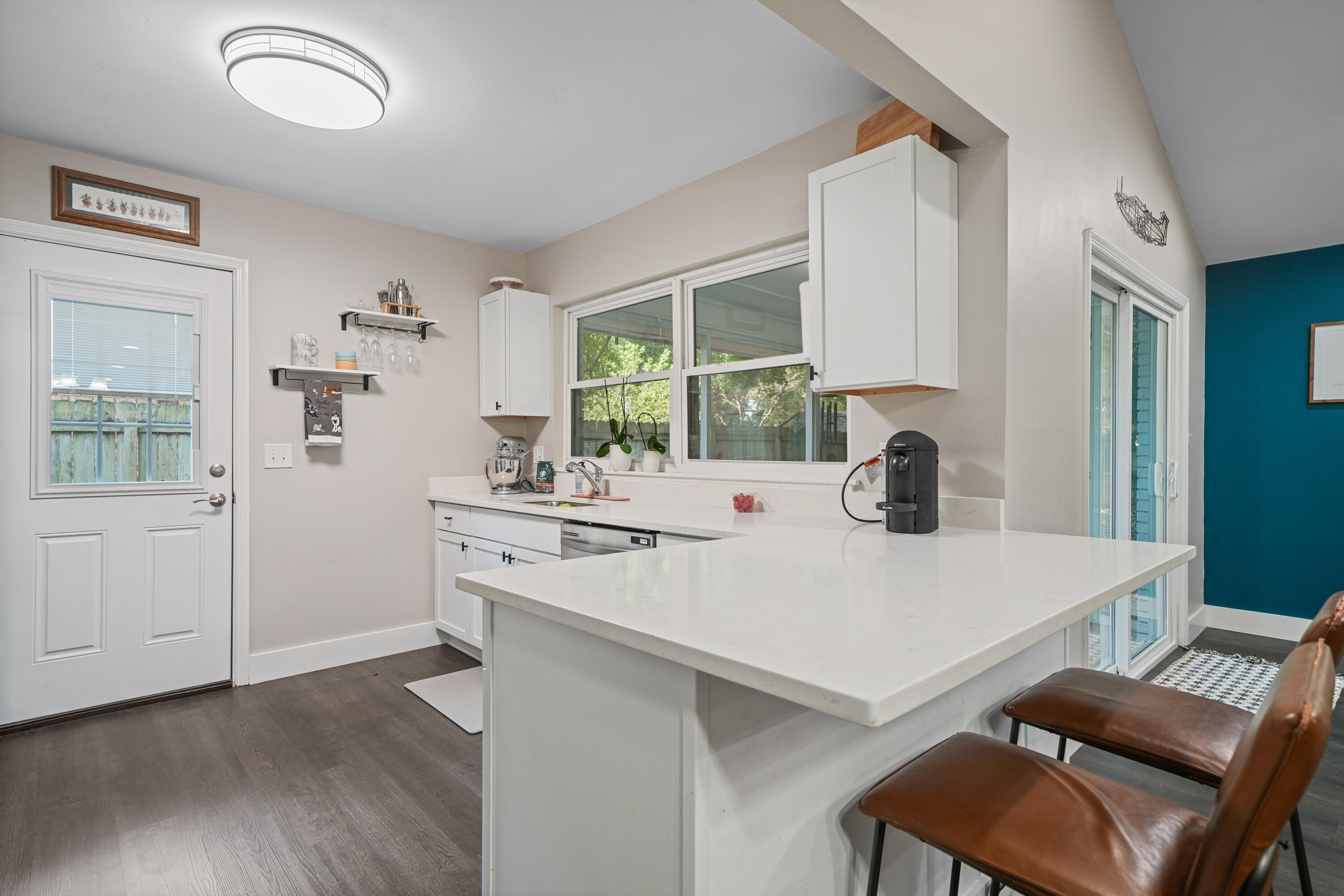 39 9th Street Shalimar, FL 32579 - Photo 3 of 37 a kitchen with a dining table chairs and white cabinets