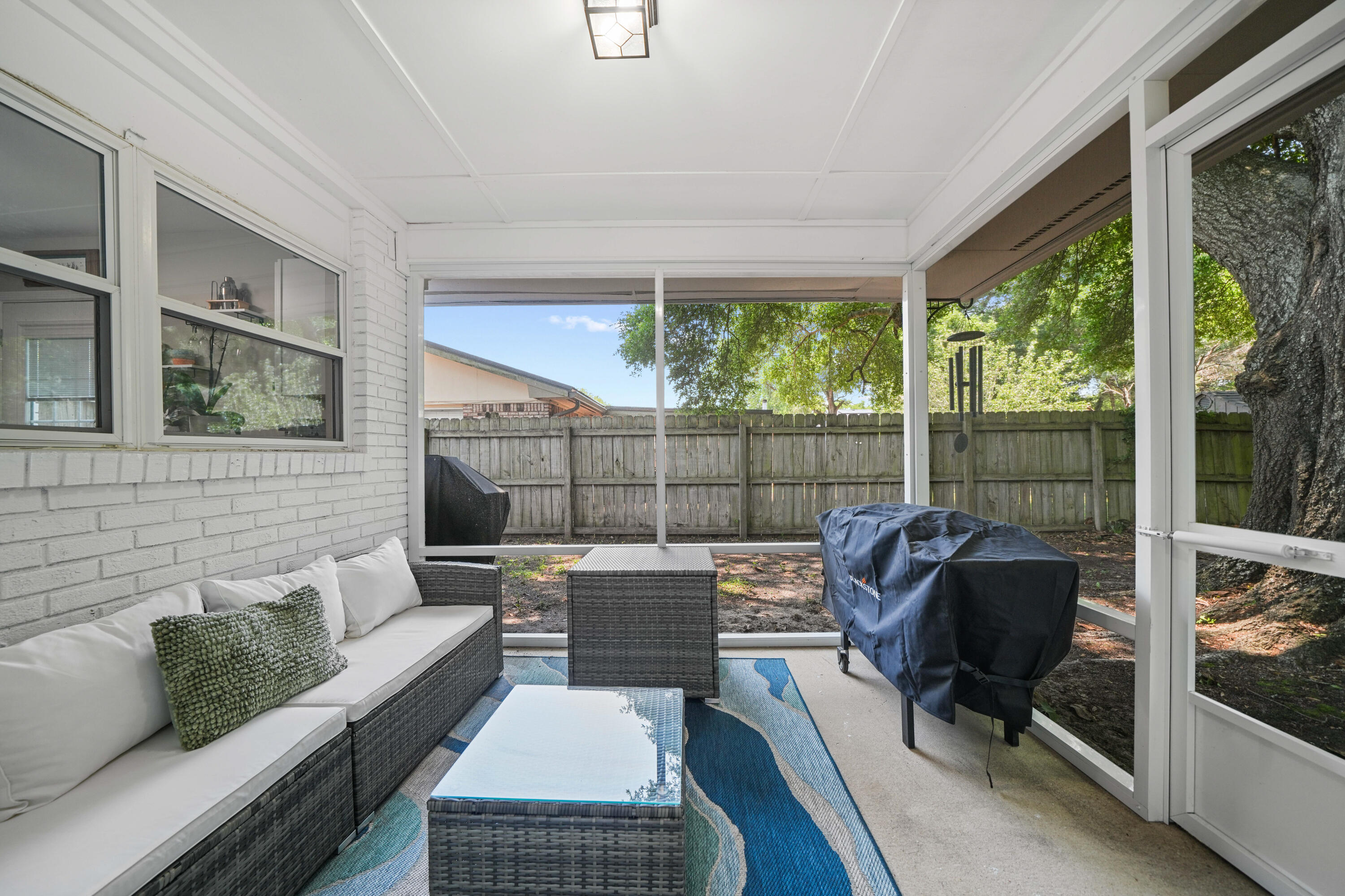 39 9th Street Shalimar, FL 32579 - Photo 32 of 37 a living room with furniture and a floor to ceiling window